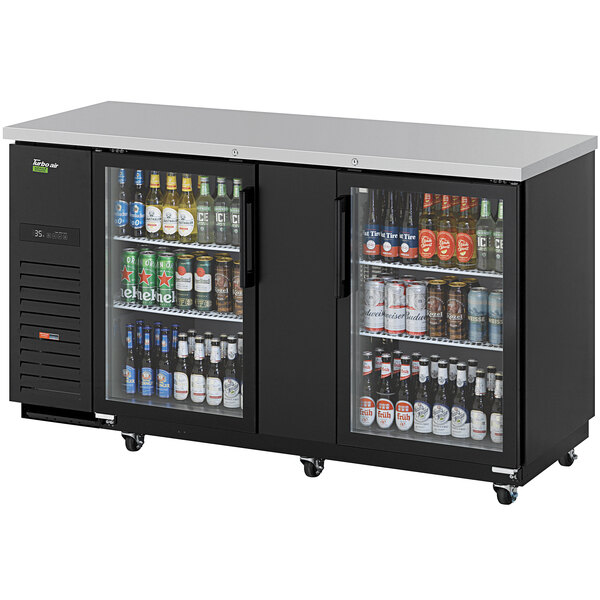 A Turbo Air Super Deluxe back bar cooler with glass doors filled with beer bottles.