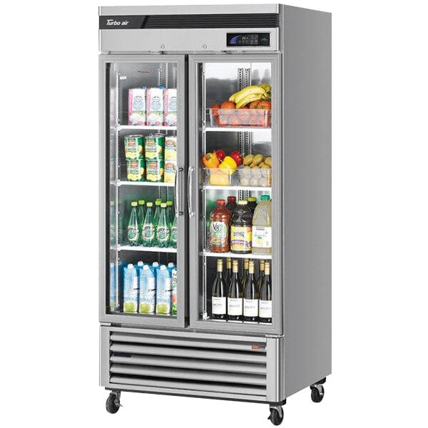 A Turbo Air reach-in refrigerator with glass doors full of drinks.
