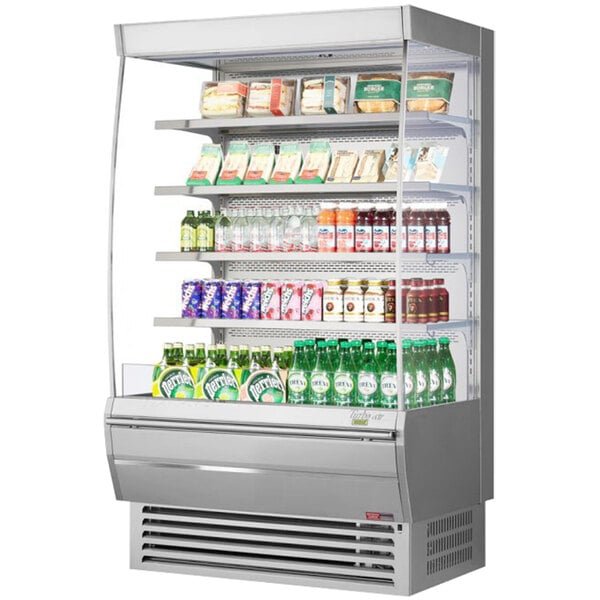 A Turbo Air stainless steel vertical open display case filled with drinks and beverages.