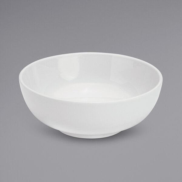A Oneida Tundra warm white china salad bowl on a gray surface.