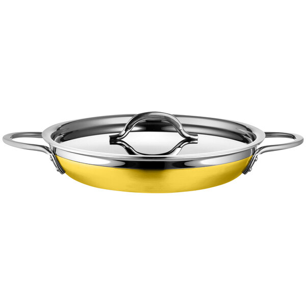 A Bon Chef stainless steel saute pan with yellow double handles.