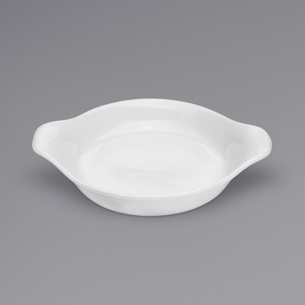 A white Oneida Tundra shirred egg dish with a handle on a white background.