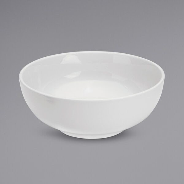 A white Oneida Tundra serving bowl with a white rim on a white surface.