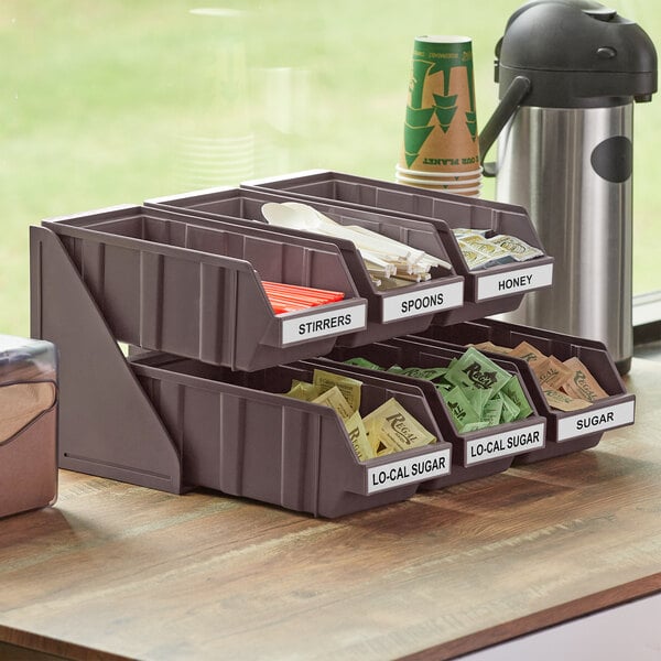 A brown 2-tier Choice self-serve organizer on a counter with bins of sugar.