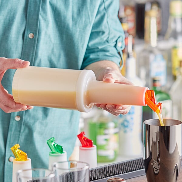 A person pouring liquid from a Choice plastic bottle with an orange flip top into a cup.