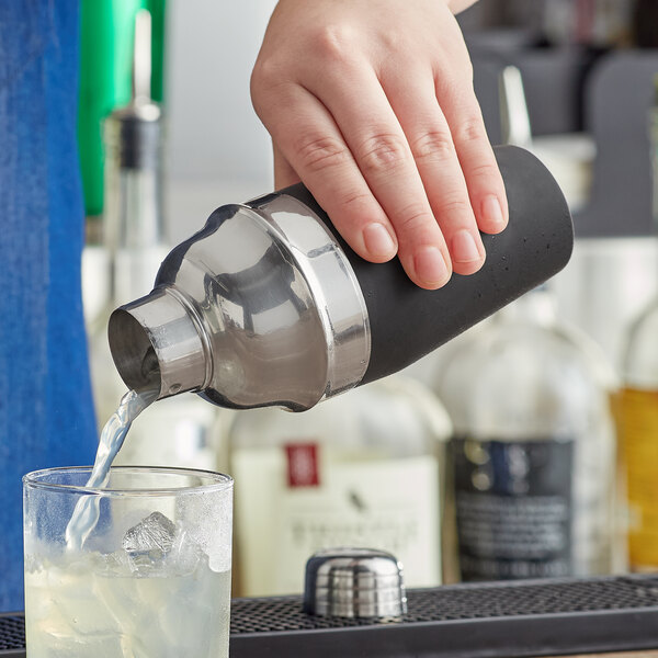A person using a Franmara soft grip cobbler cocktail shaker to pour a drink.