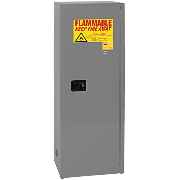 A gray metal Eagle Manufacturing safety cabinet with a yellow and red safety sign.
