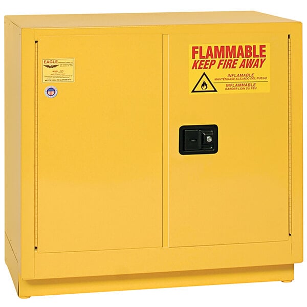 A yellow metal cabinet with a red sign that says "flammable" and "Eagle Manufacturing 22 Gallon Flammable Liquid Safety Cabinet"