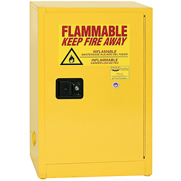 A yellow Eagle Manufacturing flammable liquid safety cabinet with a red and black warning sign.