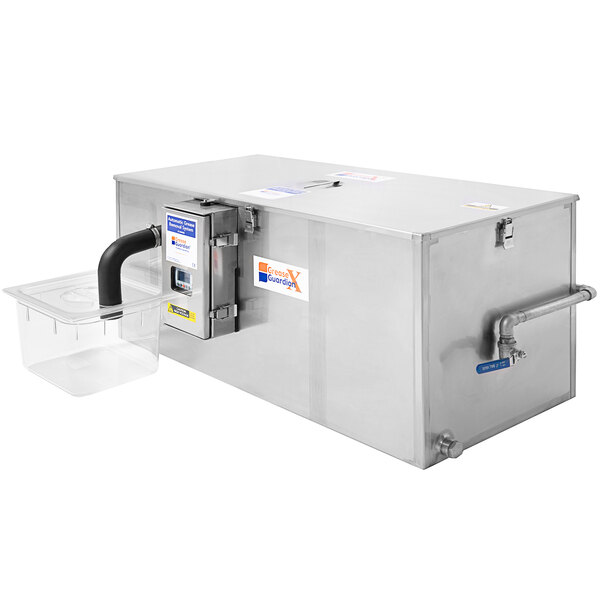 A large metal Grease Guardian GGX50 automatic grease trap with a clear container inside.