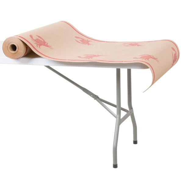 A roll of crab patterned paper table cover on a table.