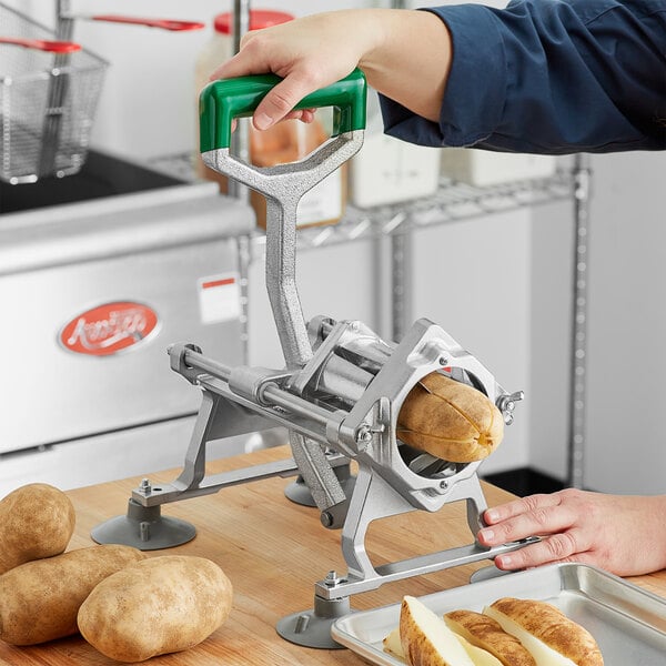 A person using a Garde potato wedge cutter on a table to cut potatoes.
