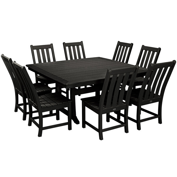 A POLYWOOD black dining table with a square top and chairs around it on an outdoor patio.