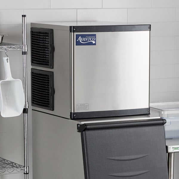 An Avantco stainless steel and black air cooled full cube ice machine.