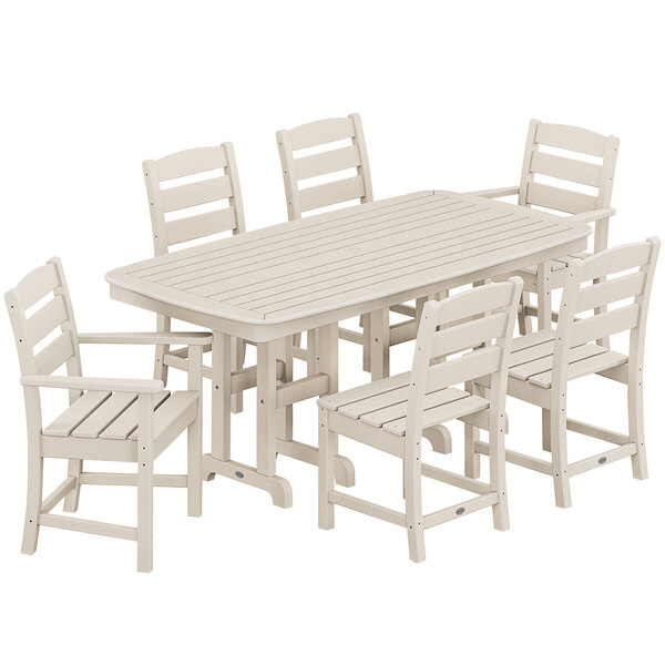A POLYWOOD table and chairs set with white chairs on an outdoor patio.