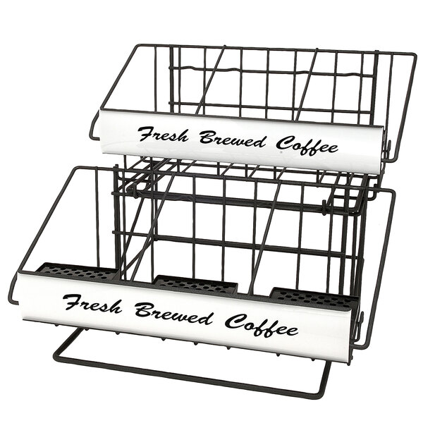 A black wire rack with two black wire baskets holding coffee cups on a counter with white labels.