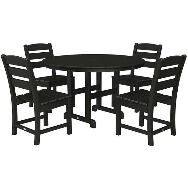 A black POLYWOOD round dining table with four chairs around it.