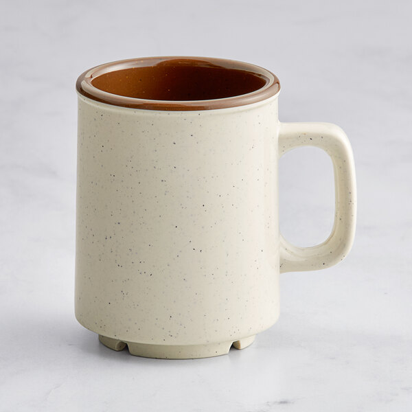 A white melamine mug with a brown handle.
