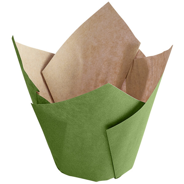 A green paper baking cup with tan folded edges.