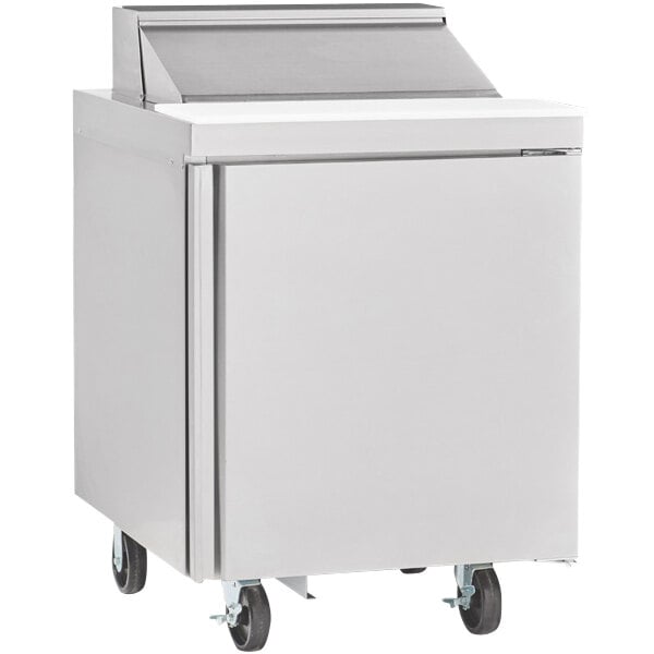 A Delfield stainless steel refrigerator with a door on wheels.