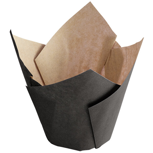 A black paper baking cup with tan paper on top.