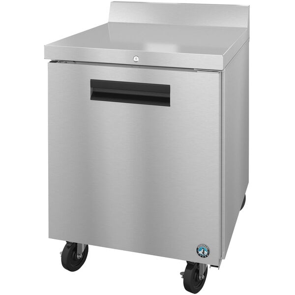 A silver Hoshizaki worktop refrigerator with black wheels and a black handle.