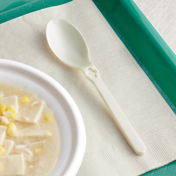 A white tray with a WeGo Natural Compostable CPLA spoon on it.
