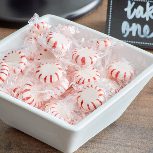 A bowl of Peppermint Starlite Mints with a sign that says take one.