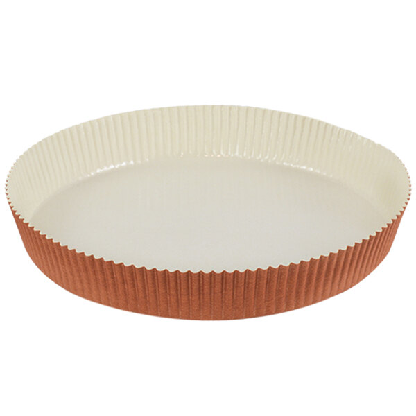 A close-up of a brown and white Novacart paper baking mold with a rim.