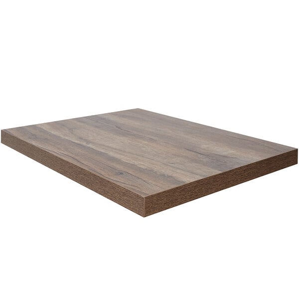 A BFM Seating knotty pine rectangular table top with a dark brown wood surface.