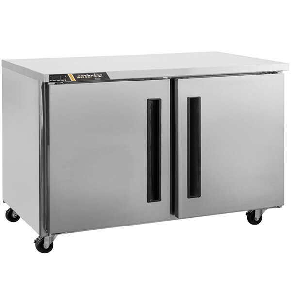 A silver Traulsen undercounter refrigerator with two doors.