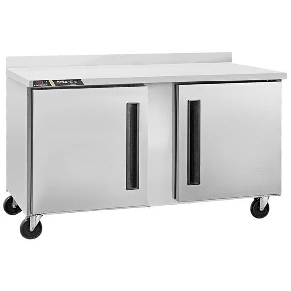 A stainless steel Traulsen worktop refrigerator on wheels.