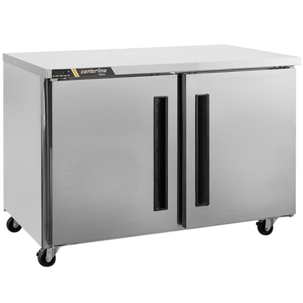 A silver Traulsen undercounter freezer with two left hinged doors.
