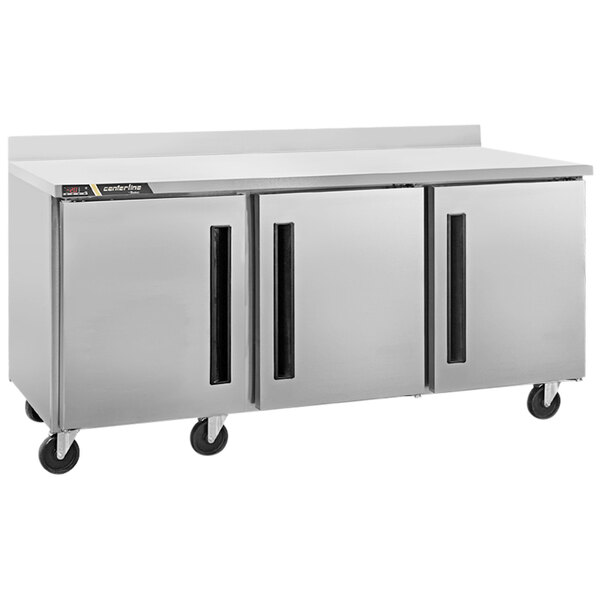 A large stainless steel Traulsen worktop freezer with three doors.