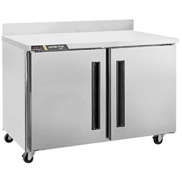 A white Traulsen compact worktop freezer with two doors.