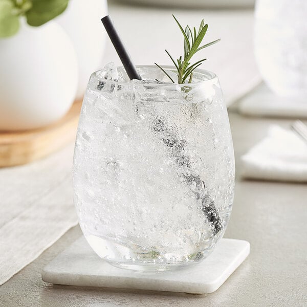 A white stemless wine glass filled with ice water and a rosemary sprig.