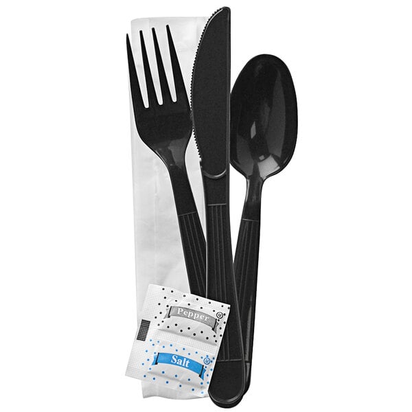 A black plastic wrapped Fineline ReForm flatware kit with a napkin, salt, and pepper pack.