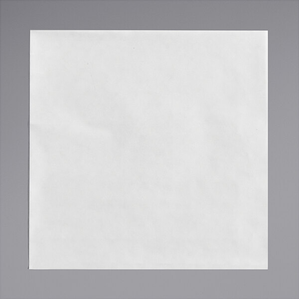 A white square Bagcraft Patty Paper with a corner