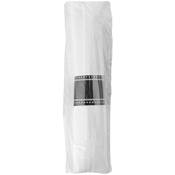 A white plastic bag with a black and white label containing black and white striped Fineline Flairware pre-rolled napkin and flatware kits.