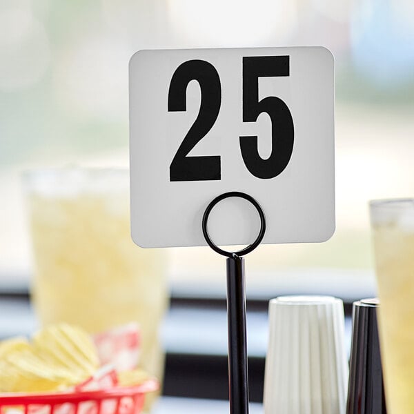 A white American Metalcraft table number card with black number 25 on it.