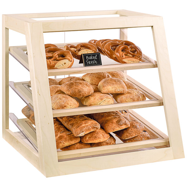 A Cal-Mil maple wood display case filled with bread and pretzels.
