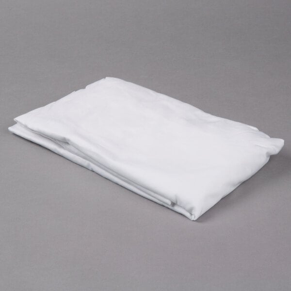 A folded white Oxford T180 Superblend fitted sheet on a gray surface.