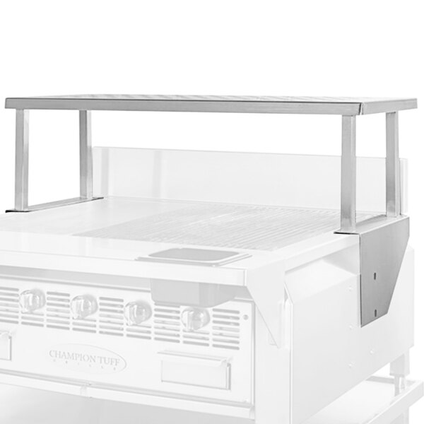 A white metal Champion Tuff Grills overshelf on a white surface above a stainless steel charbroiler.