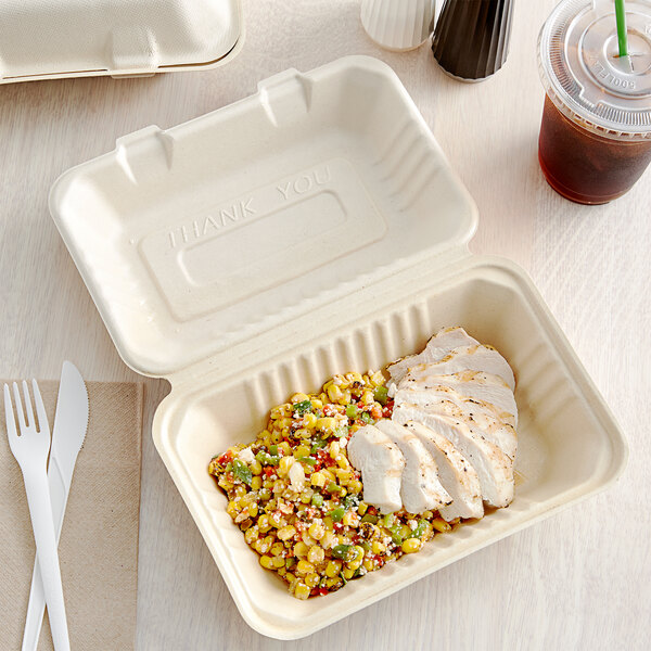 A Footprint Bagasse take-out container filled with food.