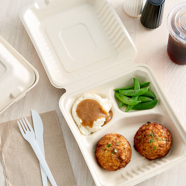 A Footprint Bagasse take-out box with food inside on a white background.