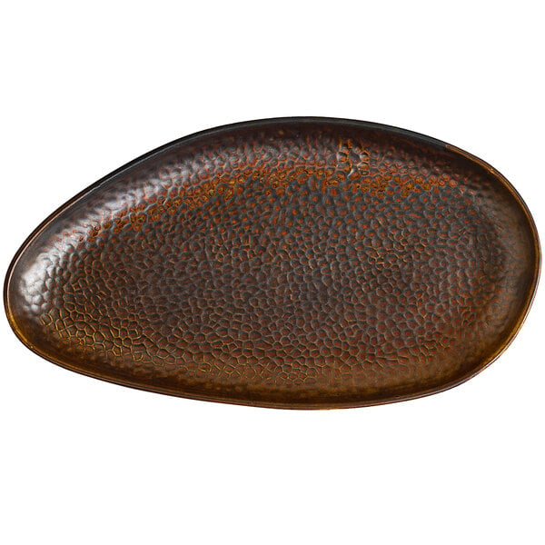 A brown oval Bon Chef Tavola porcelain dinner plate with a textured surface.