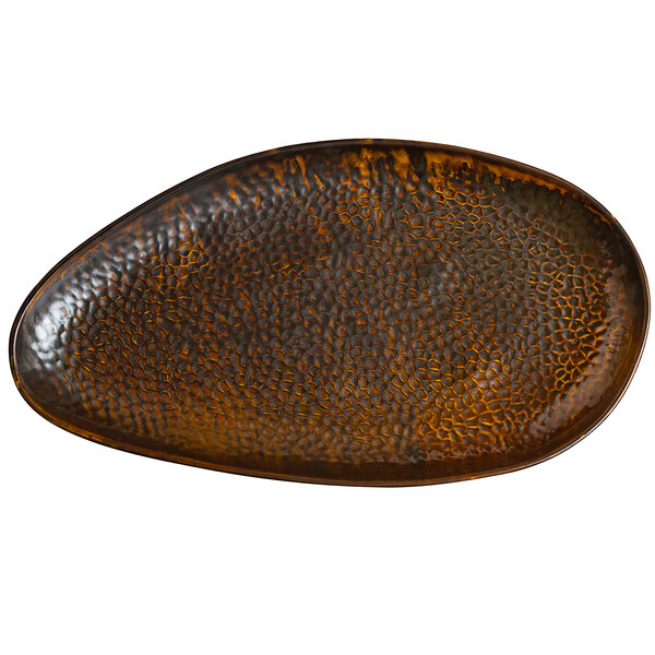 A brown oval Bon Chef porcelain plate with a textured surface.