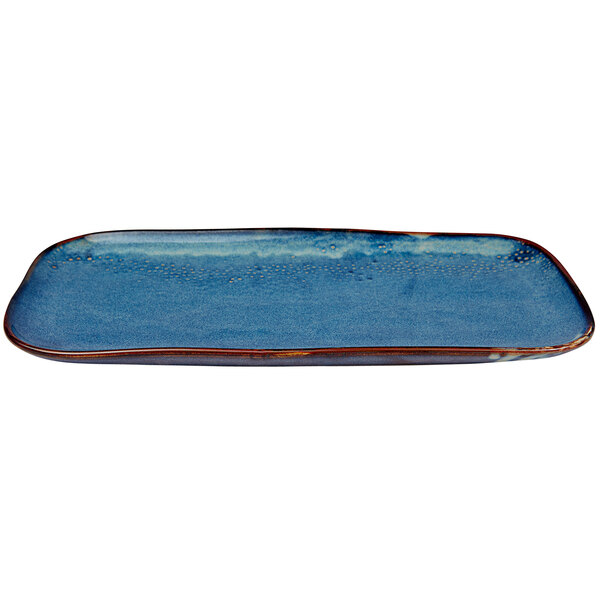 A blue rectangular porcelain platter with brown edges.