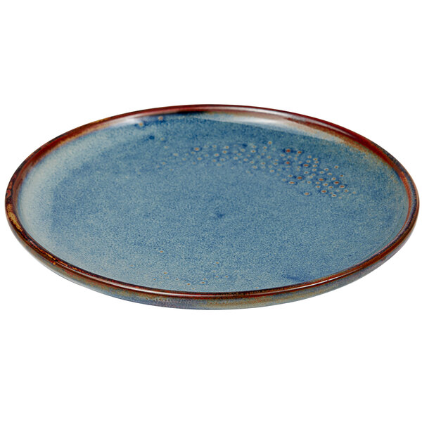 A blue porcelain bread and butter plate with a brown rim.