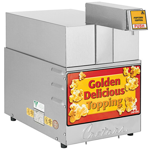 A Cretors countertop butter dispenser with a stainless steel top with a sign that says "golden delicious topping" on it.